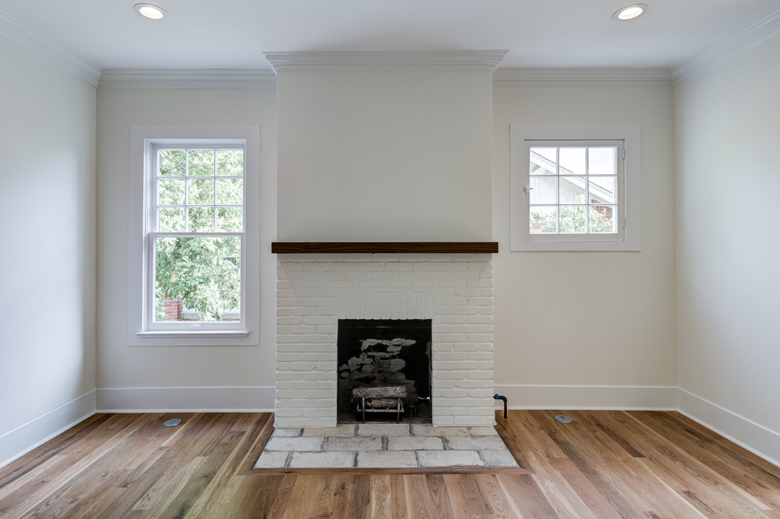 Living room fireplace with crown moulding and upgraded trim details