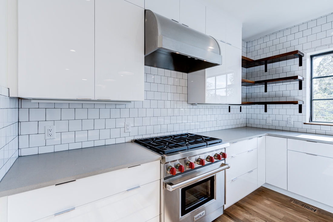 Custom kitchen cabinetry with integrated open shelving and modern finishes