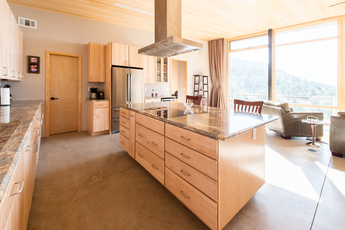 Open kitchen with custom cabinetry integrated into the room
