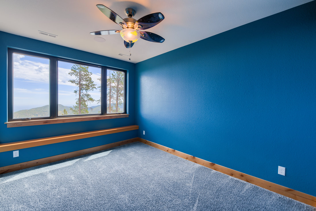 Bedroom with upgraded baseboards and natural wood window trim