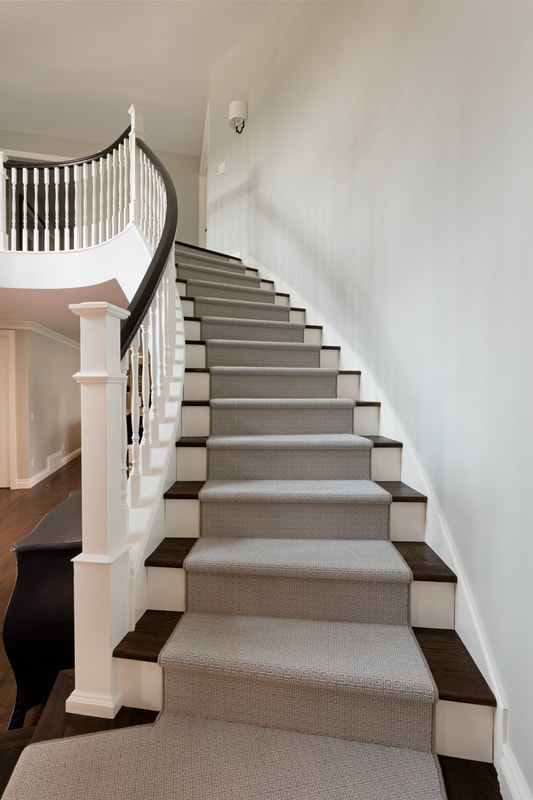 Curved staircase with upgraded trim and painted balusters