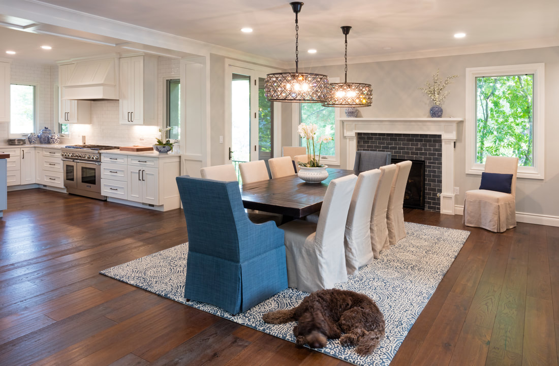 Elegant dining room with custom crown moulding, fireplace mantel, and built-in cabinetry