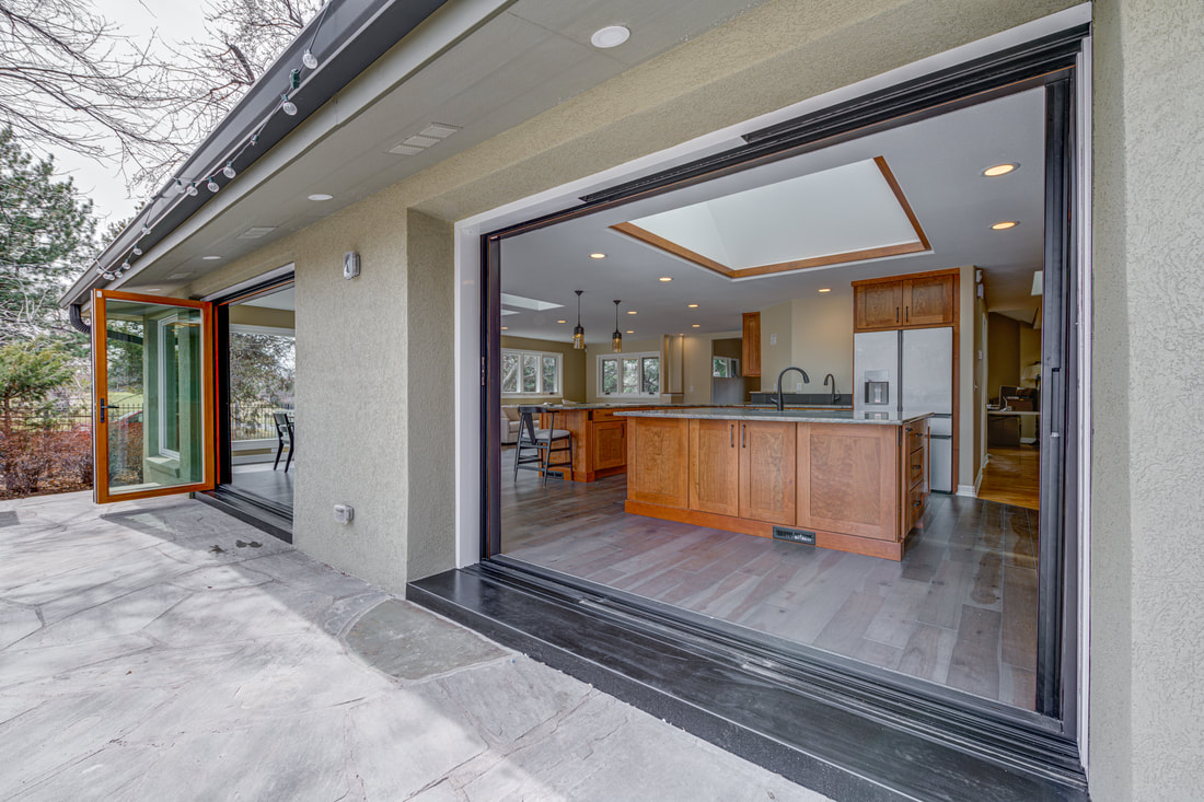 Multi-panel sliding glass doors opening from kitchen to outdoor patio