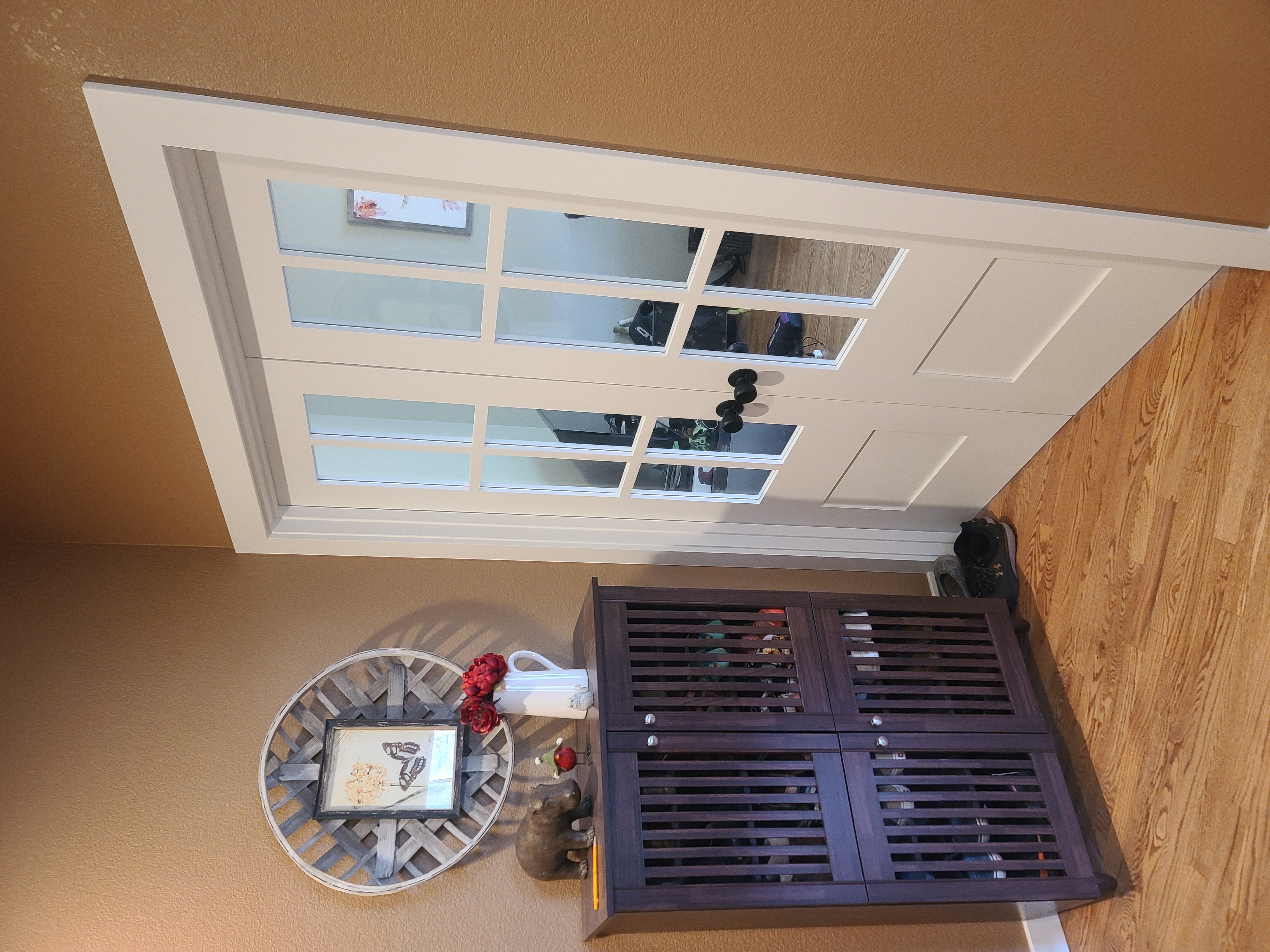 White French door with glass panes installed in warm-toned room
