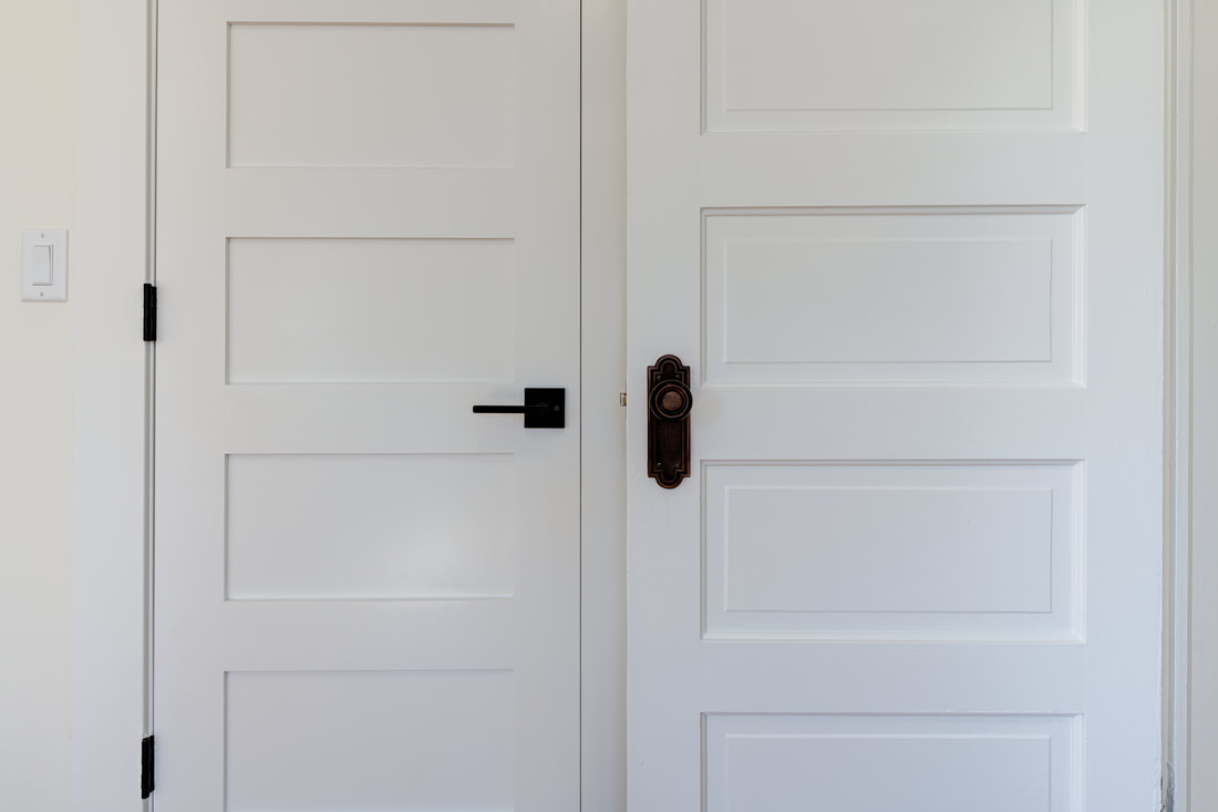 Close-up of 5-panel Shaker doors with mixed hardware styles
