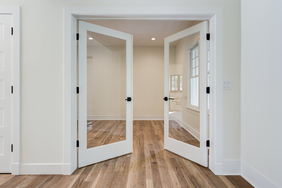 Full-lite interior french doors with matte black hardware